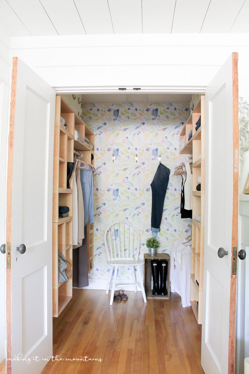 closet organization ideas, custom built in cubbies in the closet with a white chair inside