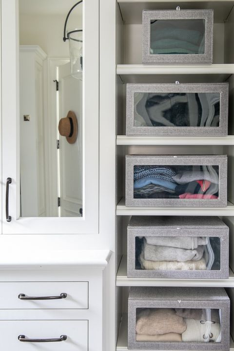 closet organization ideas see through boxes with sweater and towels on the shelves