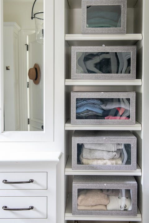 closet organization ideas see through boxes with sweater and towels on the shelves