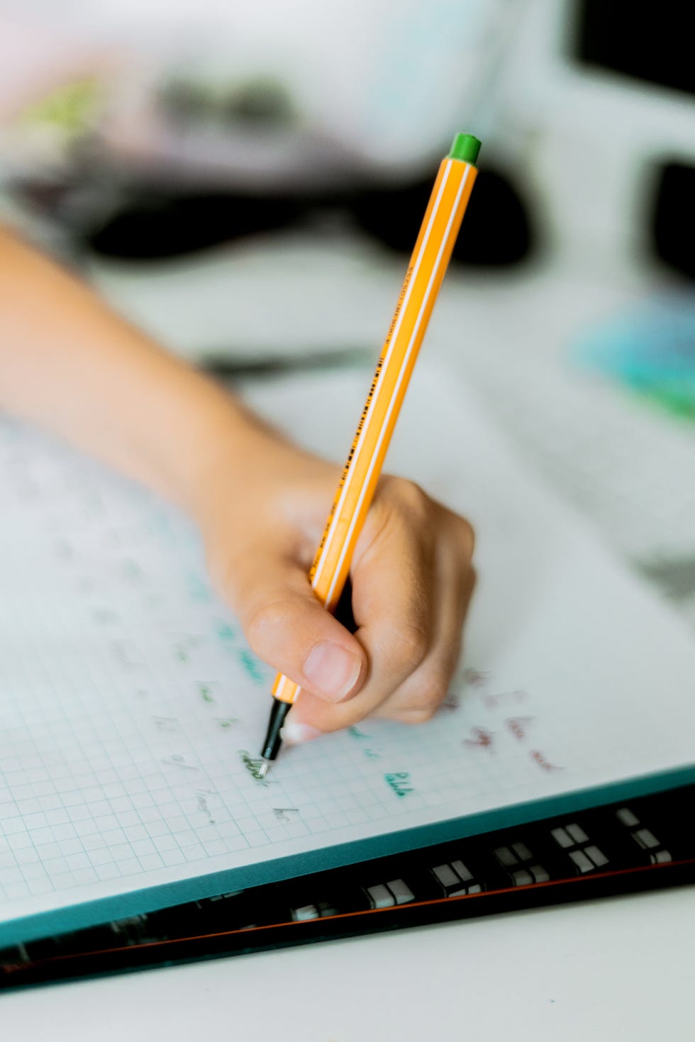 closeup image of left  handed boy doing some homeworks at home