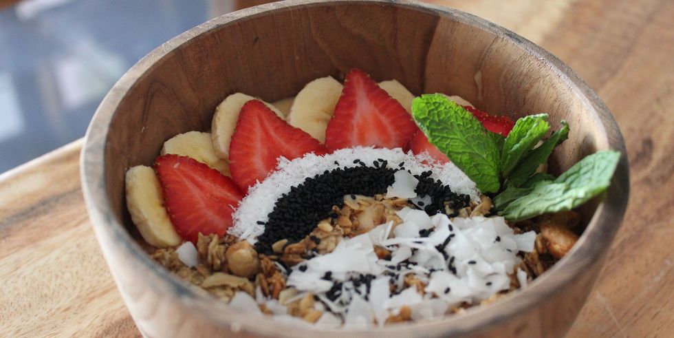 closeup of a bowl filled with granola with berries and oats