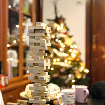 closeup of a set of stacked wooden blocks on the dining table next to the christmas tree