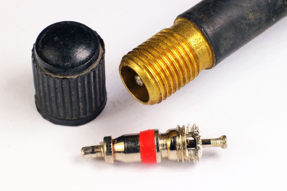Closeup of disassembled bicycle Schrader valve with cap