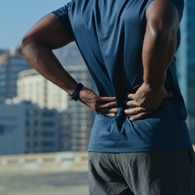 closeup shot of an unrecognisable man experiencing back back while exercising outdoors