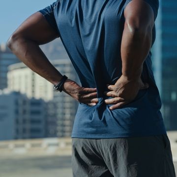 closeup shot of an unrecognisable man experiencing back back while exercising outdoors