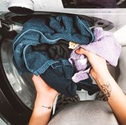 wet laundry going into clothes dryer