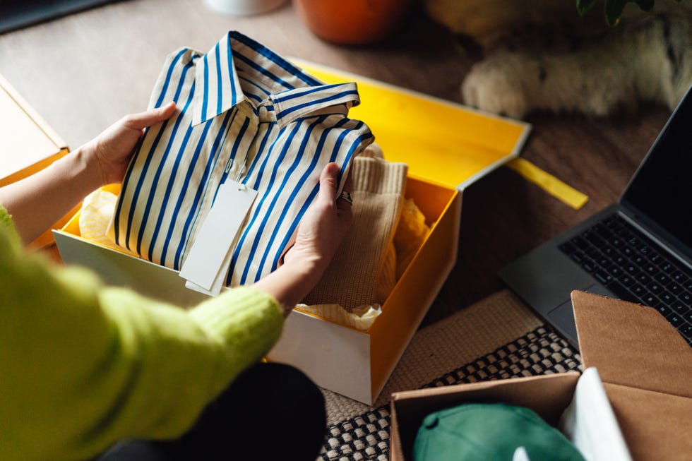 closeup of young woman unboxing a delivery from home shopping