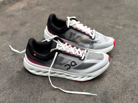 sport shoes designed for running featuring a modern design with grey black and red accents