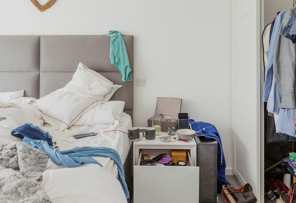 a room with a bed and a desk with a computer on it
