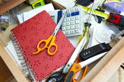 cluttered kitchen drawer filled with a confusing jumble of everyday objects