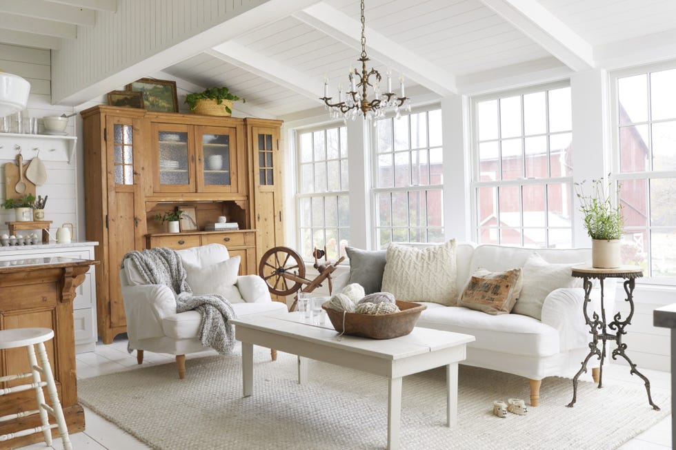 an all white living room with warm rustic wood touches