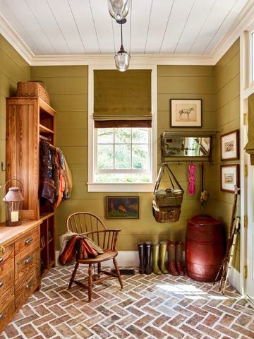 mudroom with brick floor laid in herringbone pattern