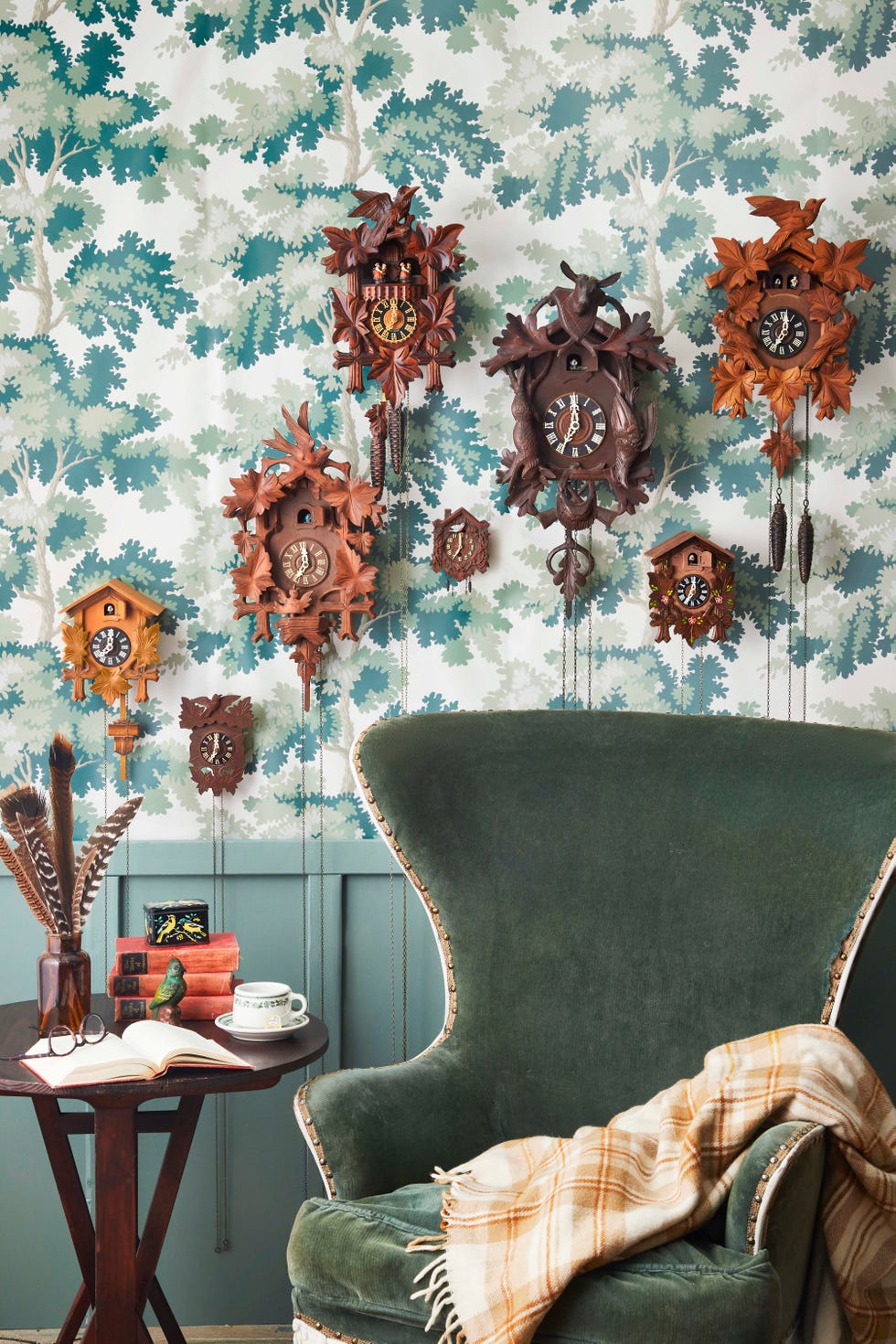 cuckoo clocks on wall over green armchair