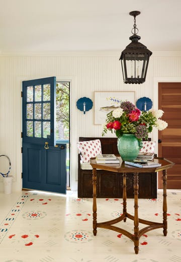 entryway with painted folk art motifs on the floor