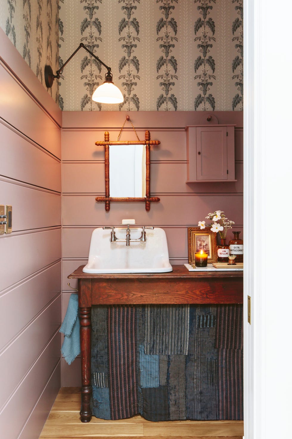 natural wood vanity in a blush colored bathroom of country home