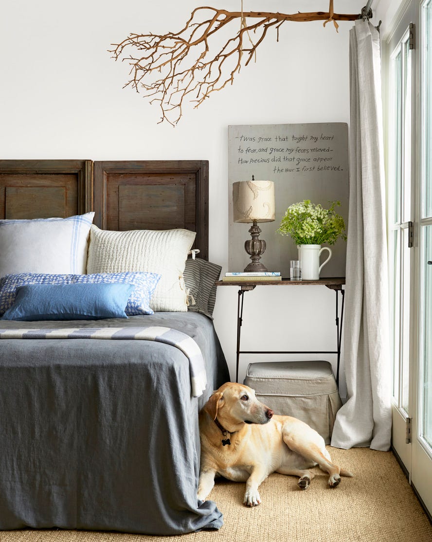 white bedroom with gray finishes, salvaged paneled shutters acting as headboard