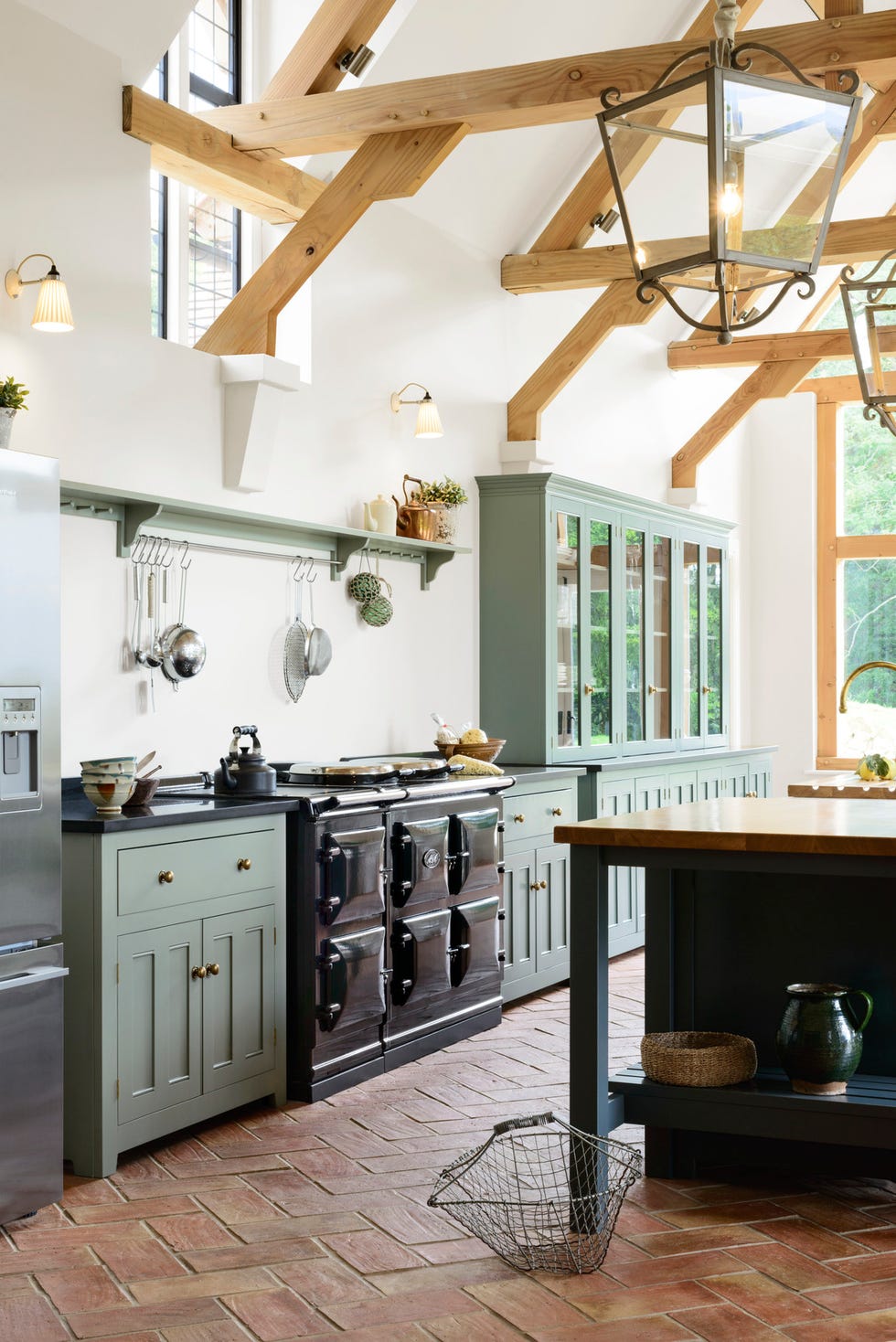 kitchen with vaulted ceilings, gray green cabinets, and black aga stove