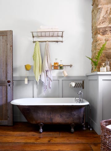 bathroom with cast iron claw foot tub gray wainscoting and white walls