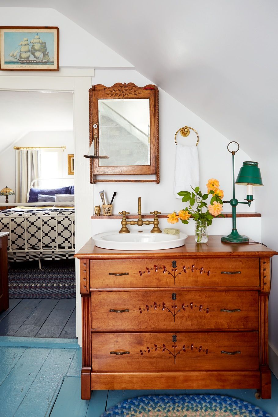 white bathroom with antique chest as sink