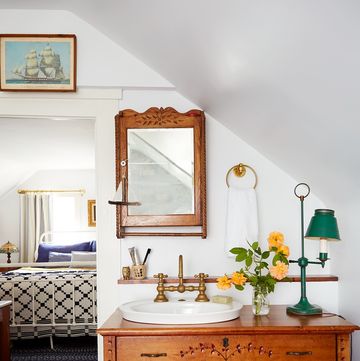 white bathroom with an antique wood dresser used as a sink