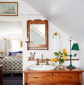 white bathroom with an antique wood dresser used as a sink