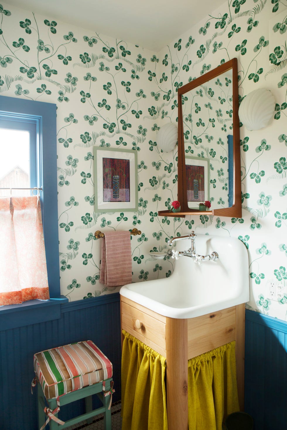 wallpapered powder room with skirted sink