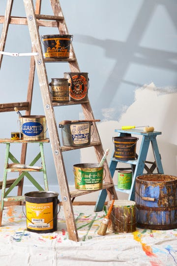 vintage pails of paint on a ladder