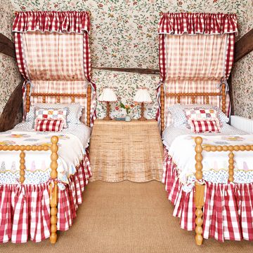 floral cottage bedroom with bobbin beds and red gingham skirts
