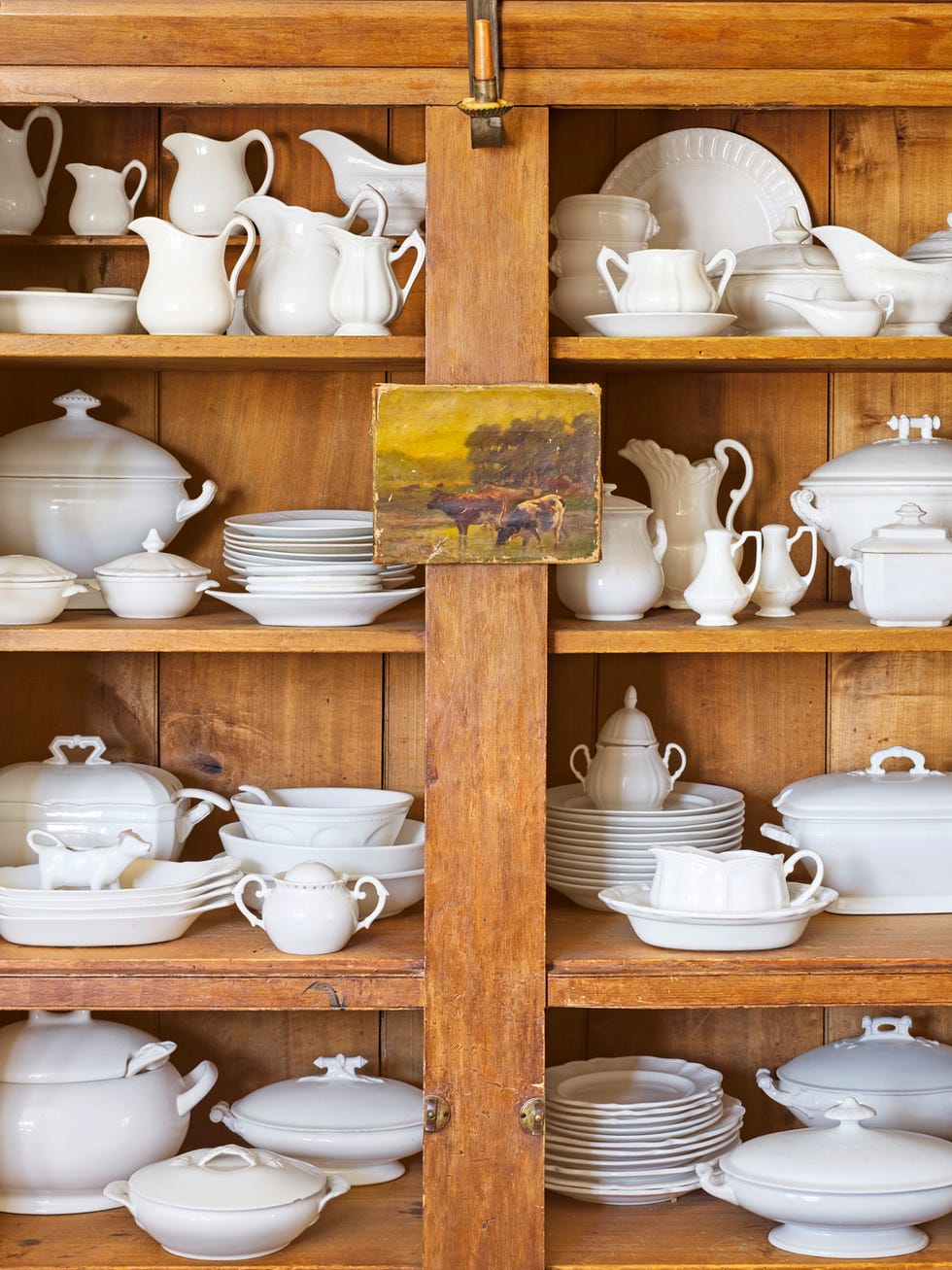 close up of ironstone in wood china cabinet