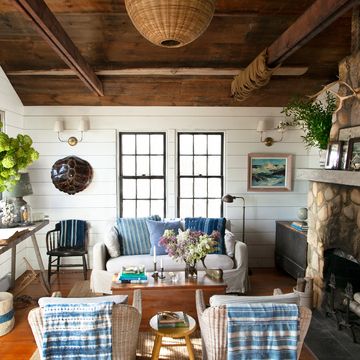 collected nautical living room with blue and white furniture and stone fireplace