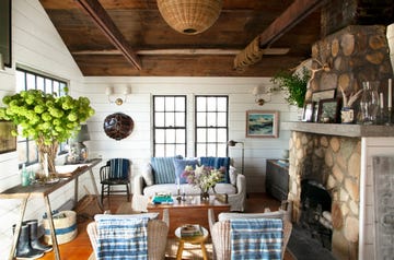 collected nautical living room with blue and white furniture and stone fireplace