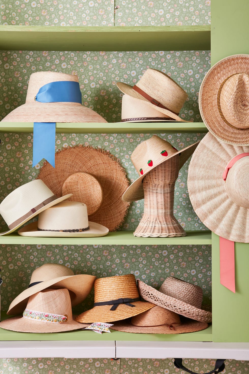 shelf decorated with straw hats on wall, vintage and new.