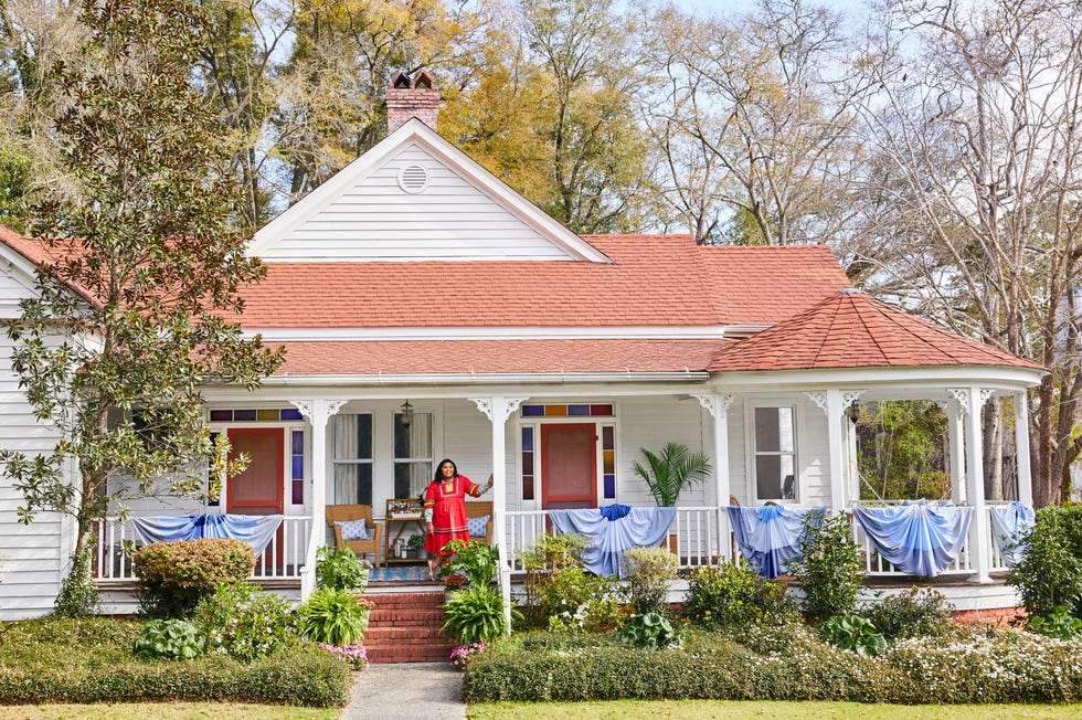 white house with wraparound porch with blue bunting white house with wraparound porch with blue bunting