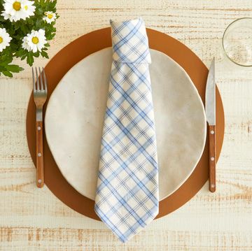 a napkin folded into the shape of a tie set on a plate