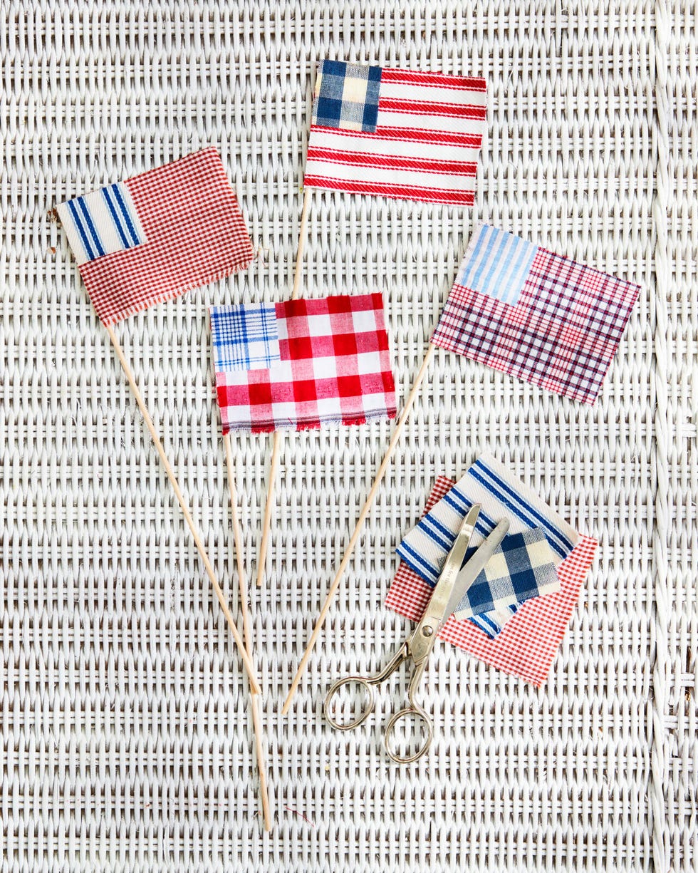 A flag made of red, white and blue fabric is placed on a wicker table