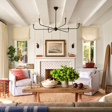 a white living room with a fireplace and rustic beach house finishes