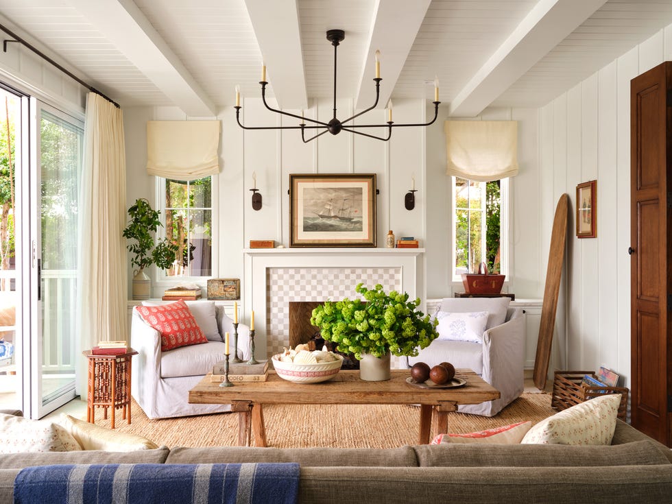 a white living room with a fireplace and rustic beach house finishes