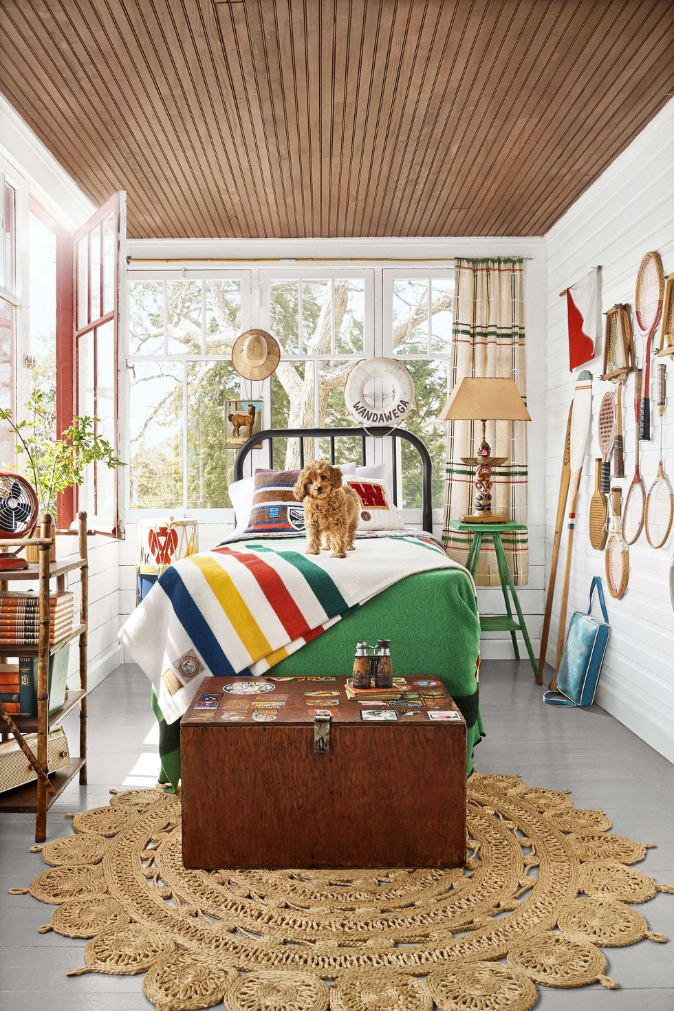bedroom with vintage footlocker  camp theme, dog on bed