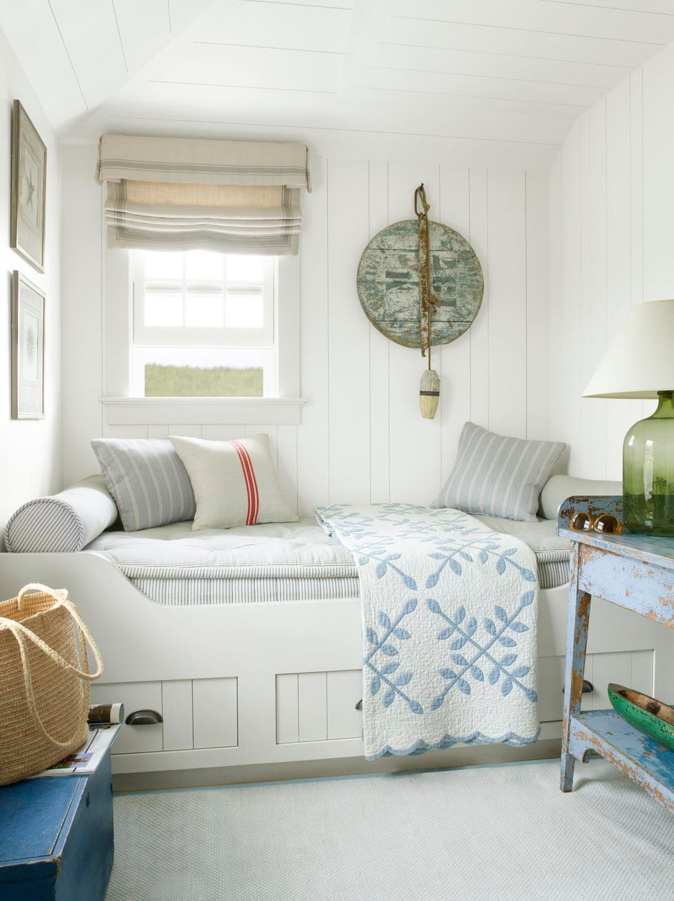 a white built in daybed with pillows