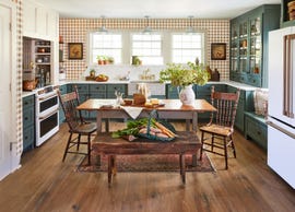 farmhouse kitchen with gingham wallpaper and green cabinets