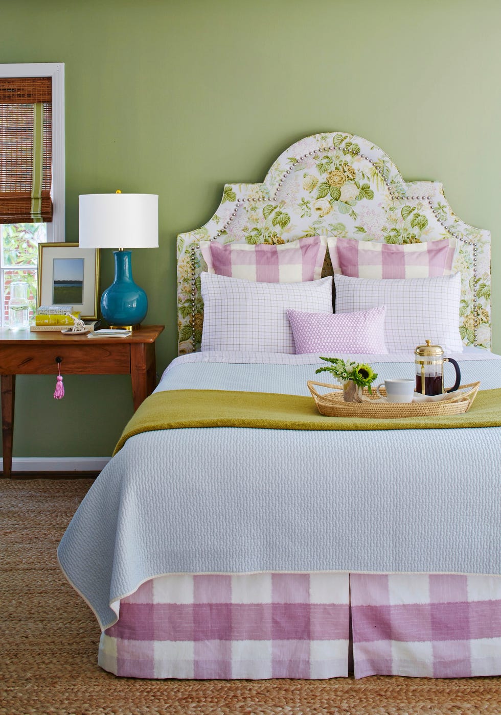 bedroom with green wall and purple and white bedding