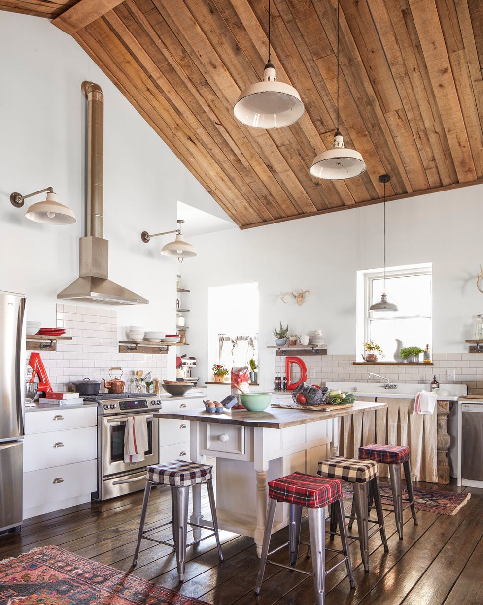 white cabin kitchen with wood ceiling and galvanized bar stools with plaid toppers