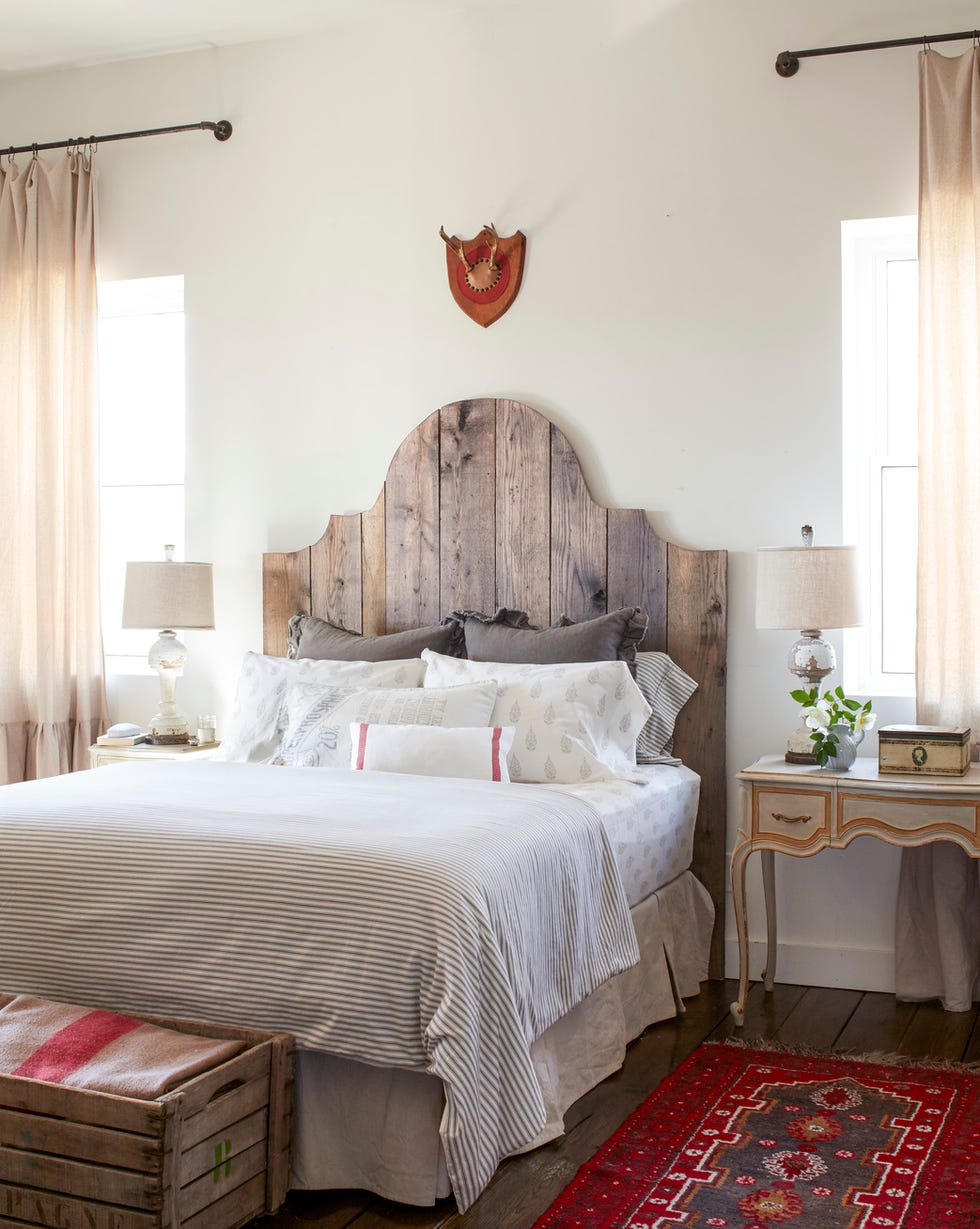 a bedroom with a wood headboard