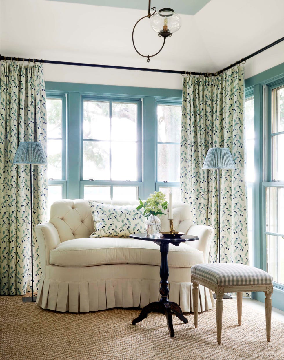 white skirted settee in a white and blue bedroom