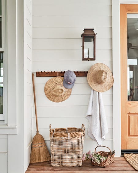 texas farmhouse of kk mckenzie and ryan mckenzie featuring their front porch entrance with antique peg rail