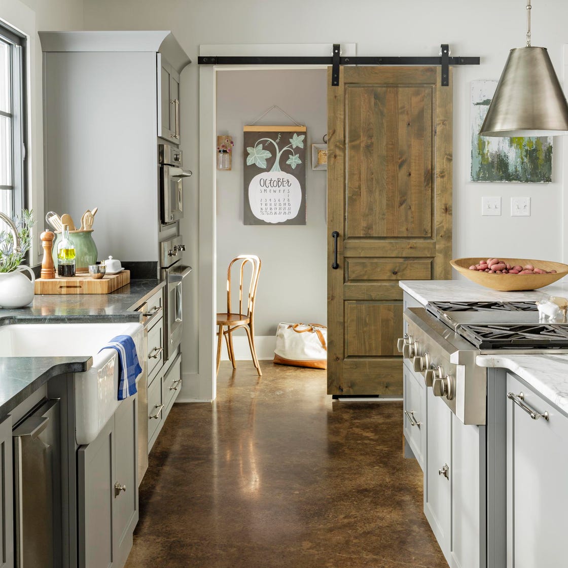 a kitchen with a sliding barn door leading into office a kitchen with a sliding barn door leading into office