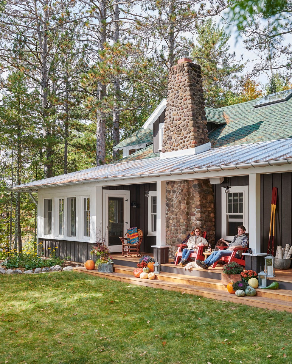 lakeside cabin front porch with pumpkins and adirondack chairs