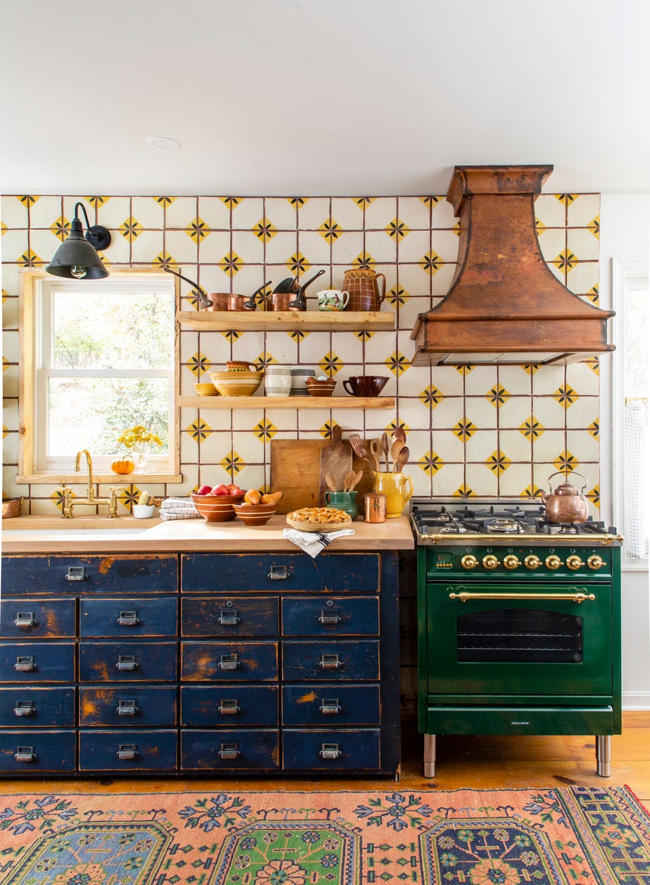 kitchen with repurposed blue card catalog as the cabinets and emerald green stove
