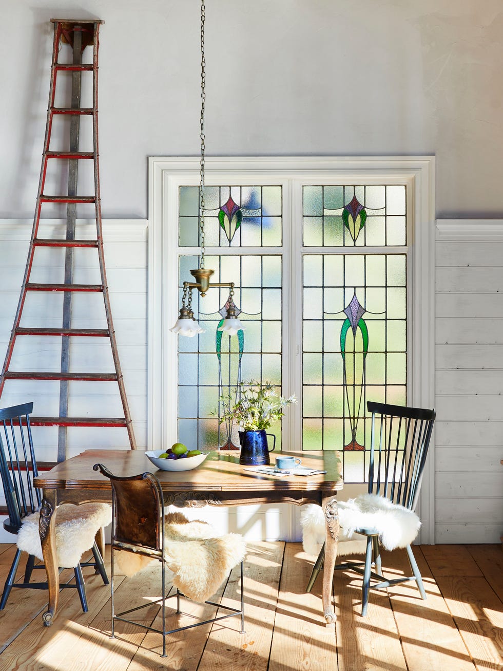 dining area featuring stained glass windows and a rustic table