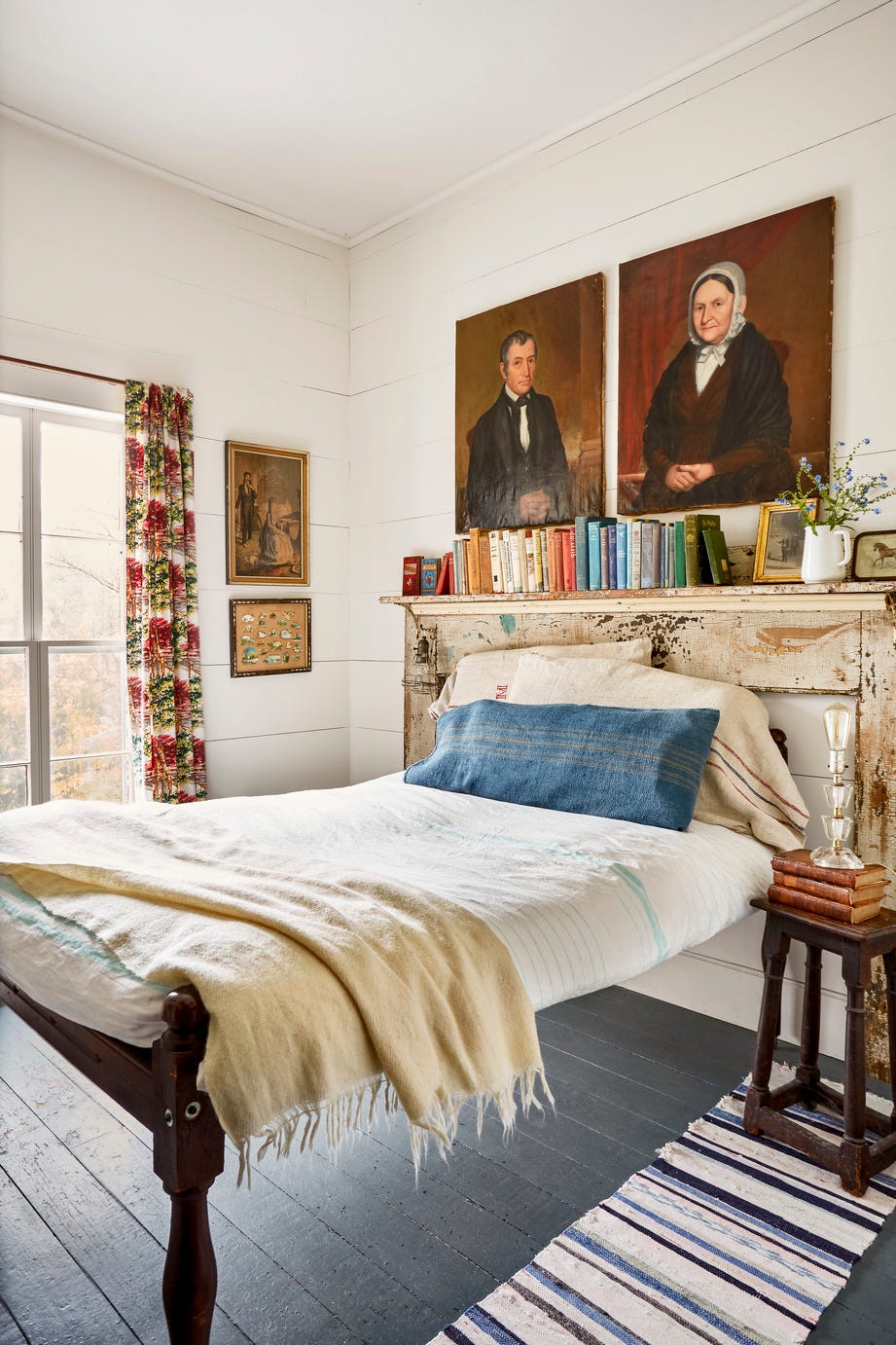 rustic white bedroom with a fireplace mantel acting as a headboard